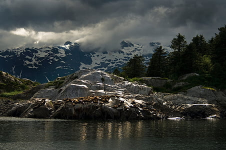 river beside mountain covered in snow thumbnail