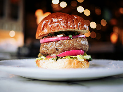 shallow focus of burger with patty, vegetable and onion thumbnail