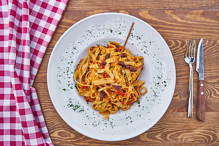 pasta in plate beside knife and fork thumbnail