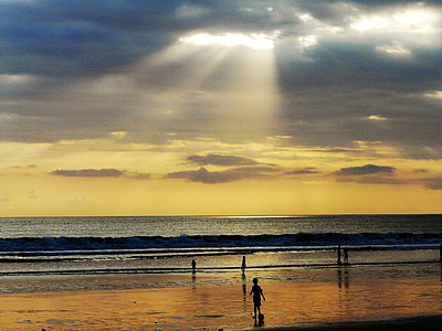 golden hour photography of kids playing beside the seashore thumbnail
