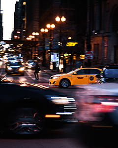 Yellow Car Passing on Road thumbnail