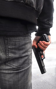 person wearing black leather jacket holding black semi-automatic thumbnail