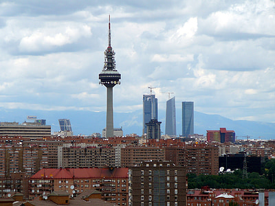 gray tower surrounded with buildings at daytime thumbnail