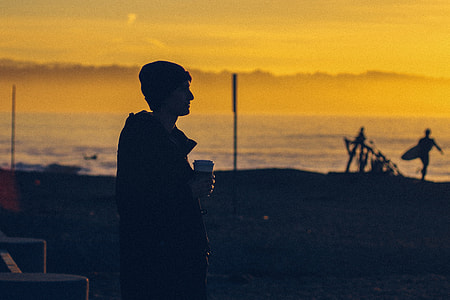 silhouette of man holding cup thumbnail