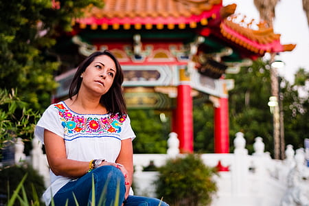 woman sitting on grass staring at sky thumbnail