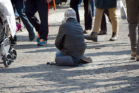 person kneeling down on concrete pavement thumbnail