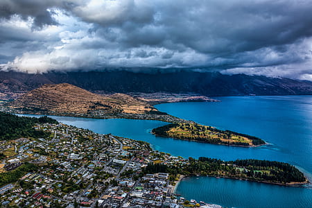 aerial shot photo of city near body of water thumbnail