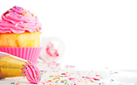 pink icing-covered cupcake on white surface thumbnail