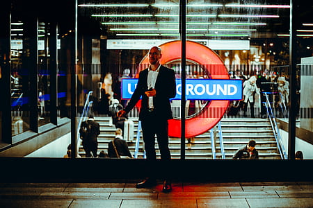 man standing near glass window thumbnail