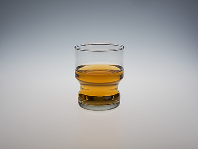 clear drinking glass filled with yellow liquid thumbnail