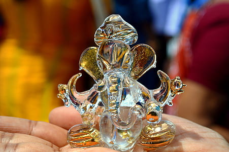 person holding clear glass table decor thumbnail