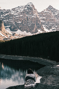 photography of woman near body of water during daytime thumbnail