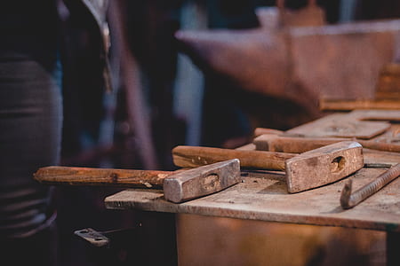 brown wooden handled hammer on brown table thumbnail