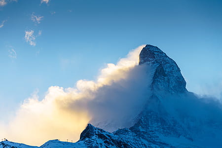 clouds covering mountain during daytime thumbnail