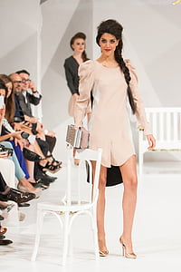 woman wearing beige dress beside chair thumbnail