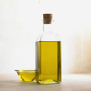 bottle and cup of olive oil thumbnail