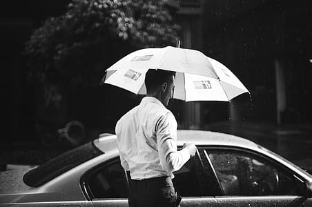person holding umbrella grayscale photo thumbnail