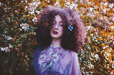woman with curly hair taking a photo thumbnail