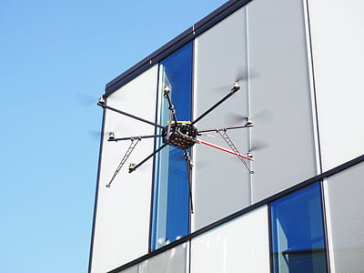 white and black drone hovering thumbnail