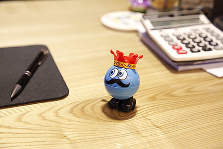 red and blue plastic toy on brown wooden surface near mouse pad and pen thumbnail