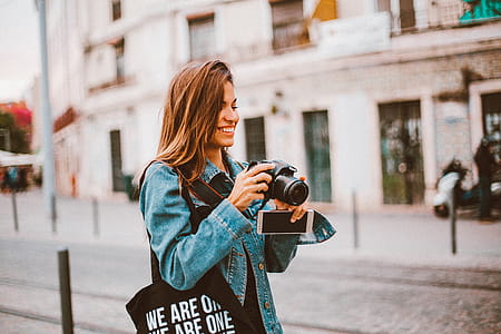 Woman Holding Black Dslr Camera thumbnail