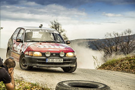 red and black Toyota Corolla on road thumbnail