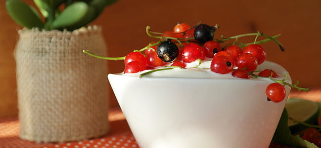 red and black currants on top on white cream thumbnail