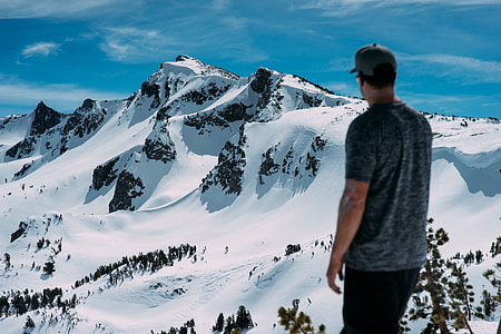 man standing on top of mountain with snow thumbnail