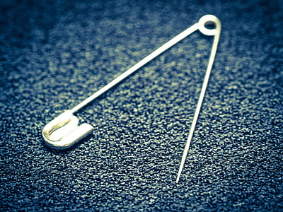 close-up photo of safety pin thumbnail