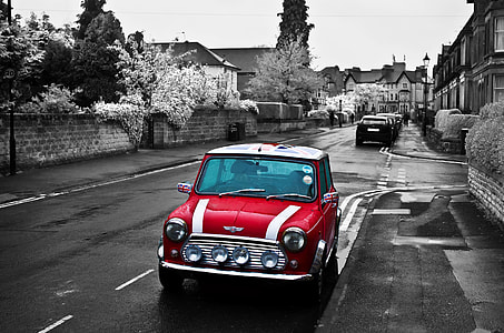 selective color photo of red Mini Cooper parked on the side of the road thumbnail