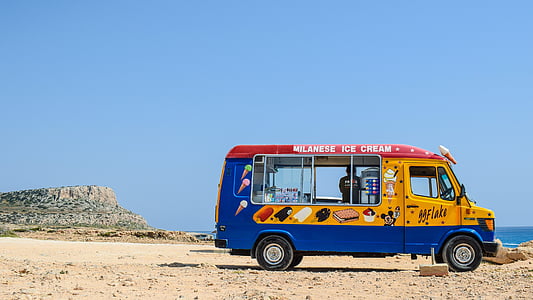 yellow and blue multi-stop van on field thumbnail