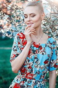 woman wearing blue and red floral scoop-neck 3/4-sleeved dress thumbnail