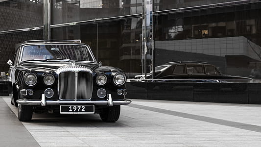 black classic car parked near building thumbnail