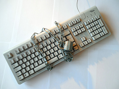 gray corded keyboard with chain and padlock thumbnail