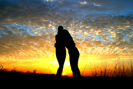 silhouette photo of two person standing thumbnail