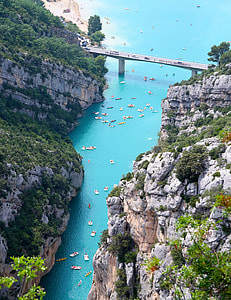 boats on body of water near mountain thumbnail