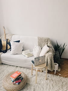 White and Black Laptop Computer on Brown Wooden Stool Near Pile Books thumbnail