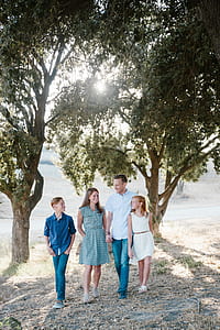 family standing under tree at daytime thumbnail