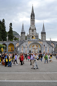 people walking beside white concrete cathedral during daytime thumbnail