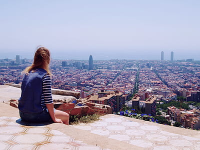 woman sitting on roof top during daytime thumbnail