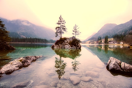 rock at the middle of calm body of water thumbnail