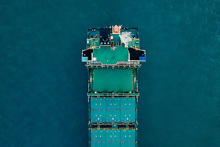 aerial photography of green boat on water during daytime thumbnail