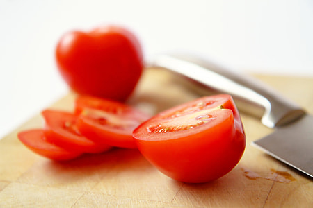 sliced tomato on brown cutting board thumbnail