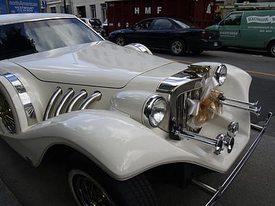 vintage white car parked on road thumbnail