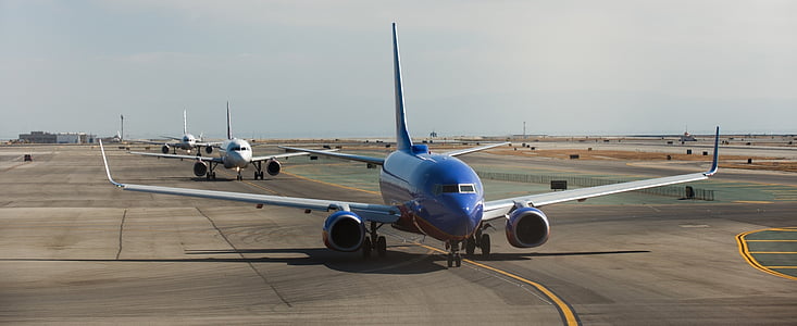 blue commercial plane on runway thumbnail