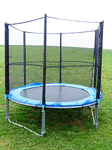 blue and black enclosed trampoline on grass field thumbnail