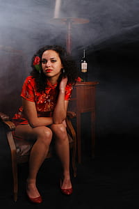 woman sitting on brown armchair posing for picture thumbnail