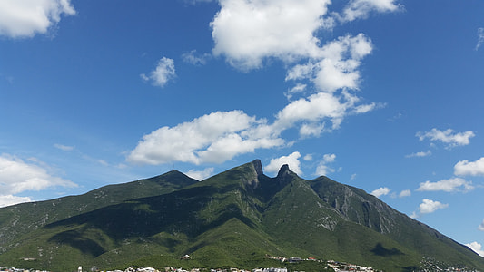 gray and green mountain under cloudy sky during daytime thumbnail