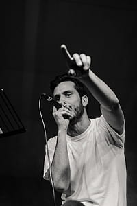man holding microphone and pointing using his finger thumbnail