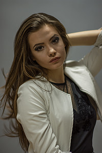 woman wearing white elbow-sleeved shirt raising her left hand looking at the camera thumbnail